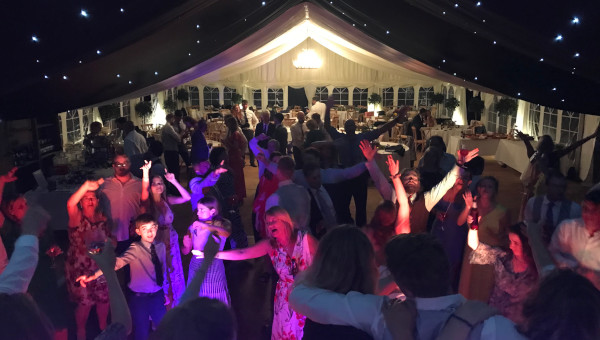 Flowers-Wedding-Crowd-Dancing-In-Marquee